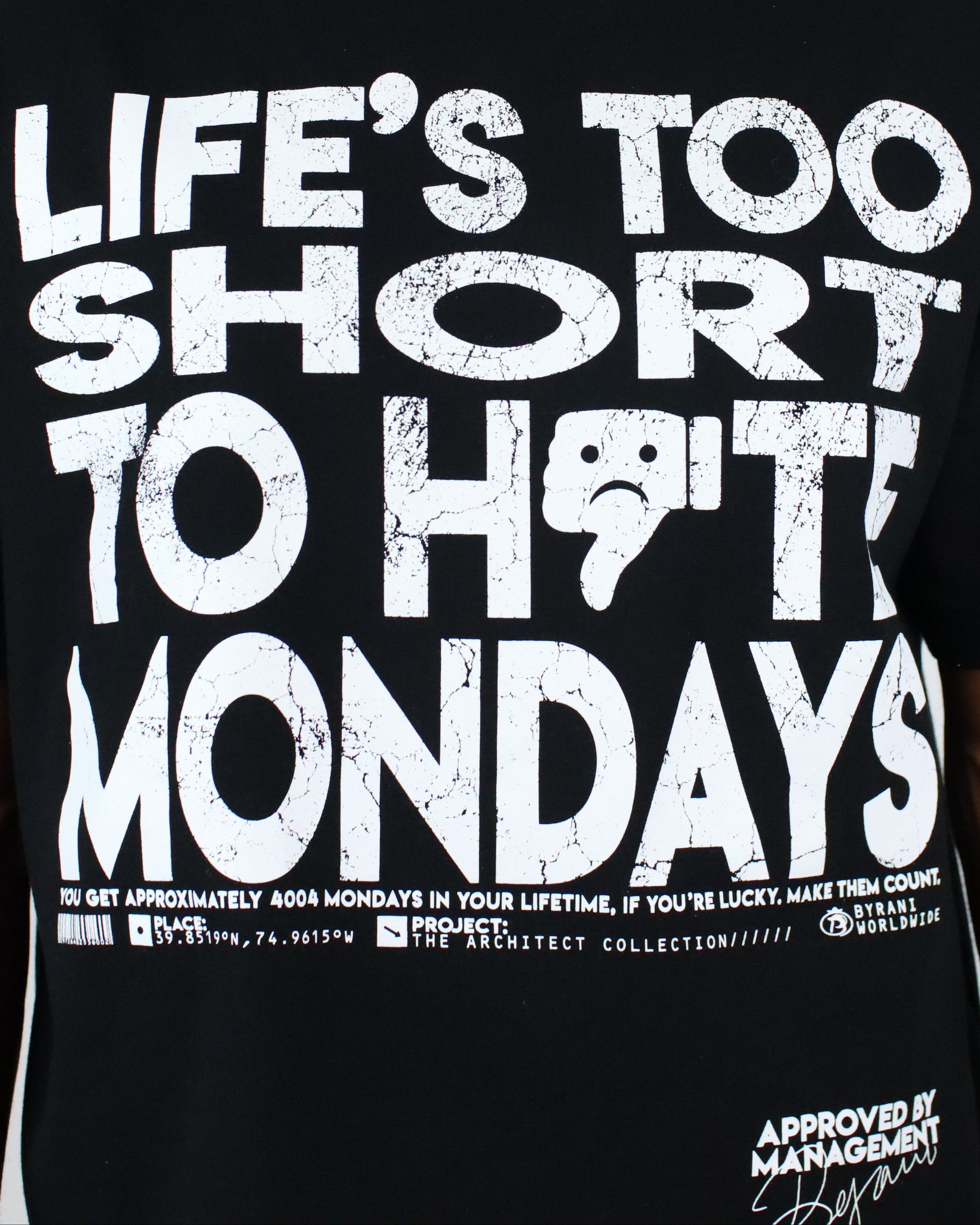 Black t-shirt with white text 'LIFE'S TOO SHORT TO HIT MONDAYS' on a plain background